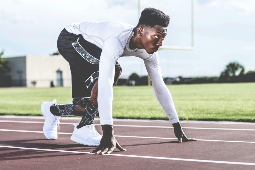 This image depicts a man getting ready to run.