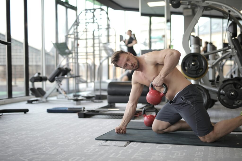 This is an image of a man boosting his back gains by doing dumbbell rows.