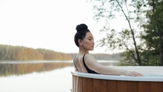 This image depicts a woman recovering in a hot tub.